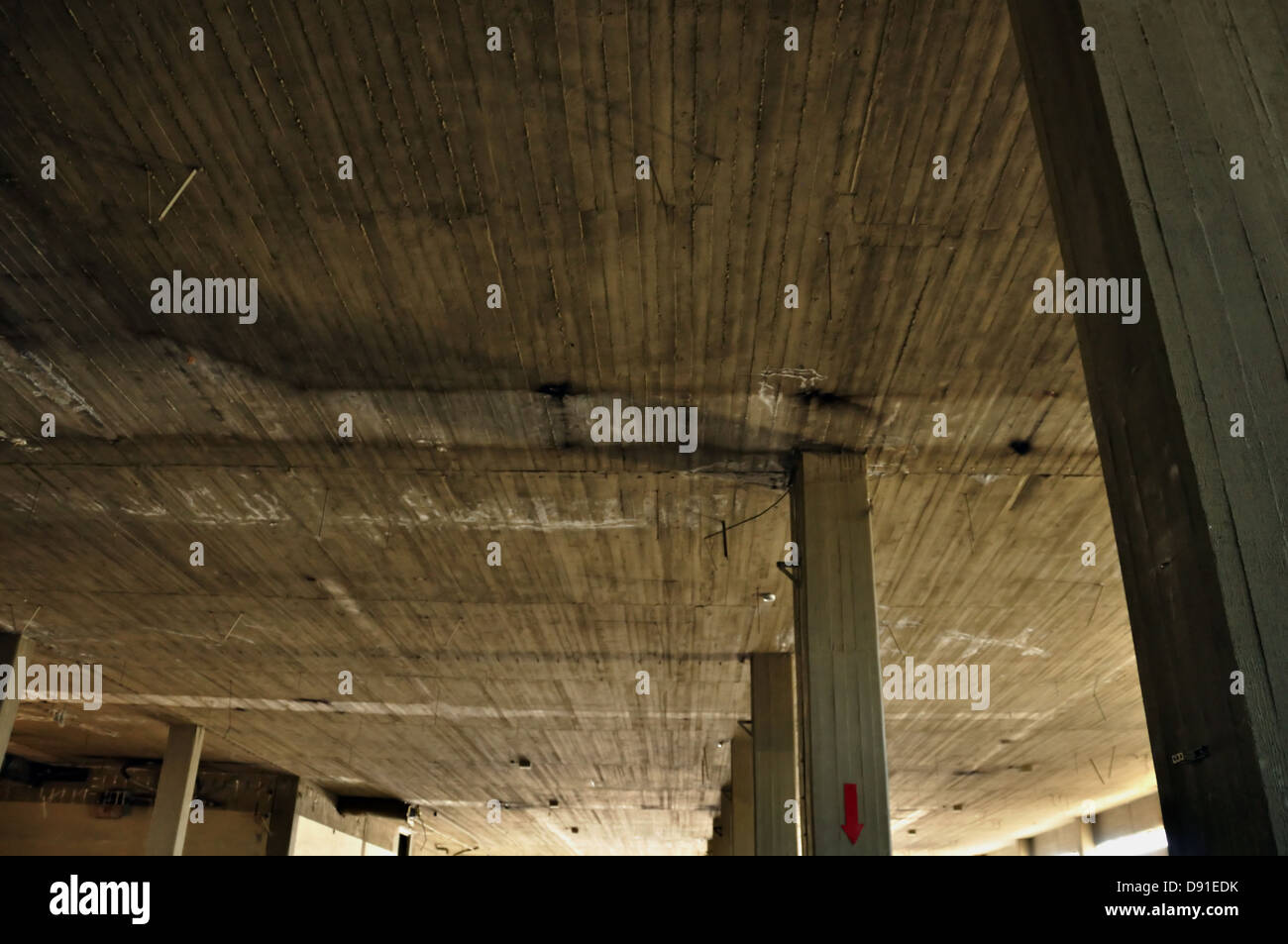 Concrete ceiling and pillars in abandoned factory interior. Industrial architecture. Stock Photo