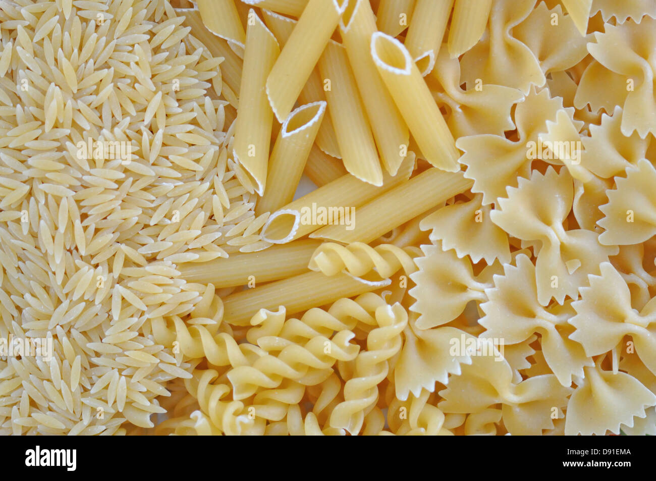 Risoni, penne, farfalle and fusilli. Italian cuisine pasta food varieties  background Stock Photo - Alamy