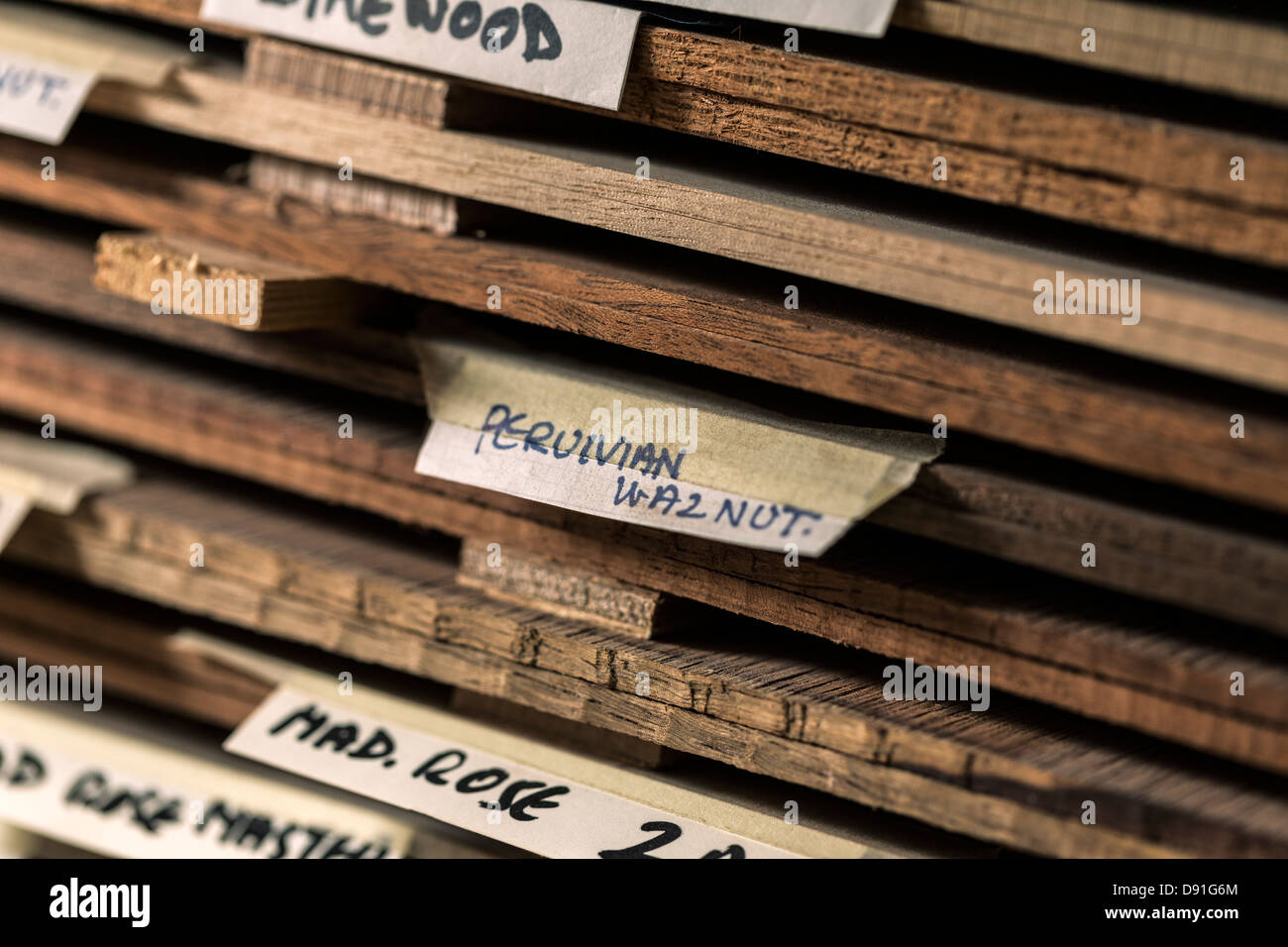 Close up of labels on different types of wood used to make acoustic guitars Stock Photo