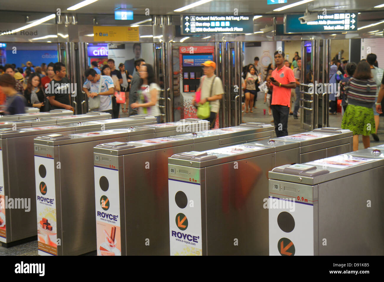 Singapore Orchard MRT Station,North South Line,subway train,riders,commuters,turnstile,baffle gate,gate,Asian man men male,woman female women,Sing1302 Stock Photo