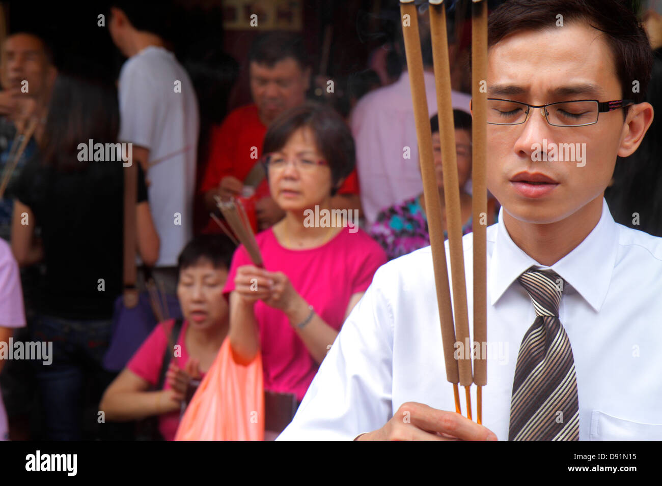 Singapore Waterloo Street,Kwan Im Thong Hood Cho Chinese Temple,incense,Asian woman female women,man men male,ritual,religion,front,entrance,Sing13020 Stock Photo