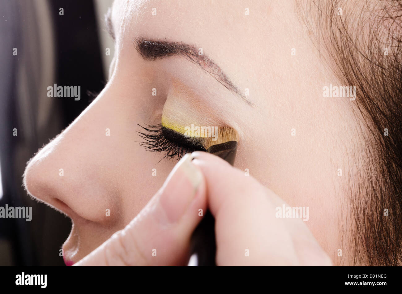 close up of woman applying makeup Stock Photo