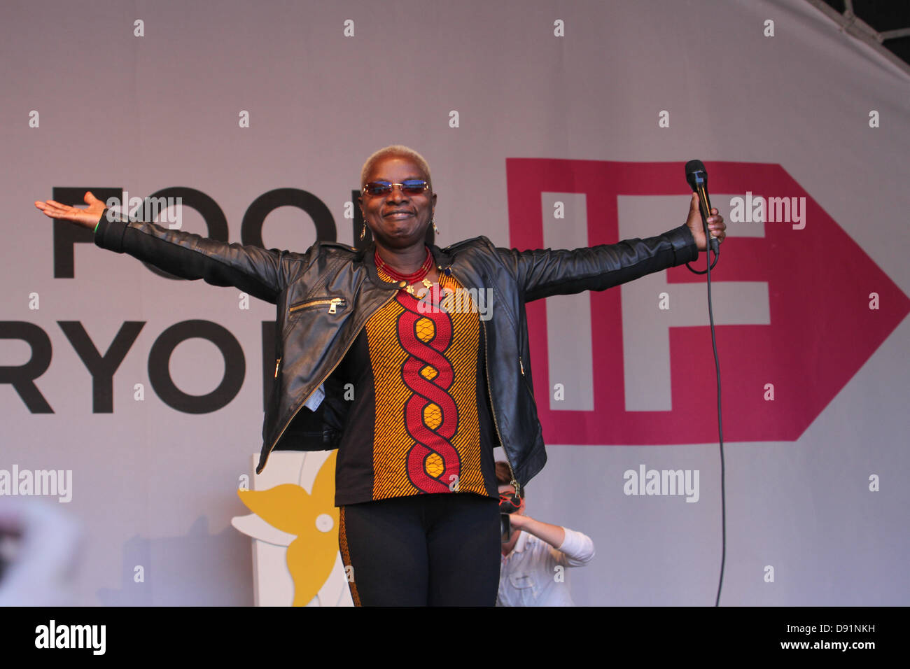 London, UK. 8th June 2013. Angelique Kidjo raises her arms as she is welcomes by the corwds onto the stage. Credit David Mbiyu/Alamy Live News Stock Photo