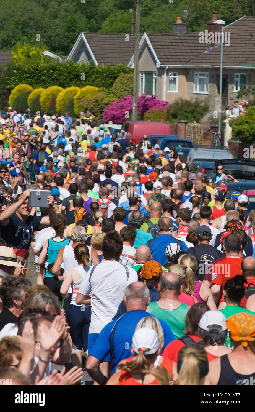 Llanwrtyd Wells, UK. 8th June 2013. Runners start at the town square. Over 400 runners compete against 65 horses in the Man V Horse 23 mile marathon, over gruelling mountainous terrain.The event was conceived by Gordon Green at his pub the Neuadd Arms in 1980 upon overhearing a discussion whether a man was equal to a horse running cross country over distance. The cash prize for beating a horse was increased each year by £1,000 until Huw Lobb won £25,000 in 2004 beating the first horse by 2 mins with a time of 2:05:19. Credit: Graham M. Lawrence/Alamy Live News. Stock Photo