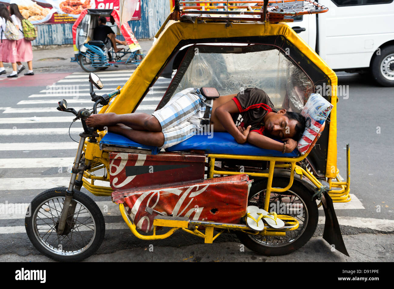 Driver sleeping on his Tricycle in Manila, Philippines Stock Photo