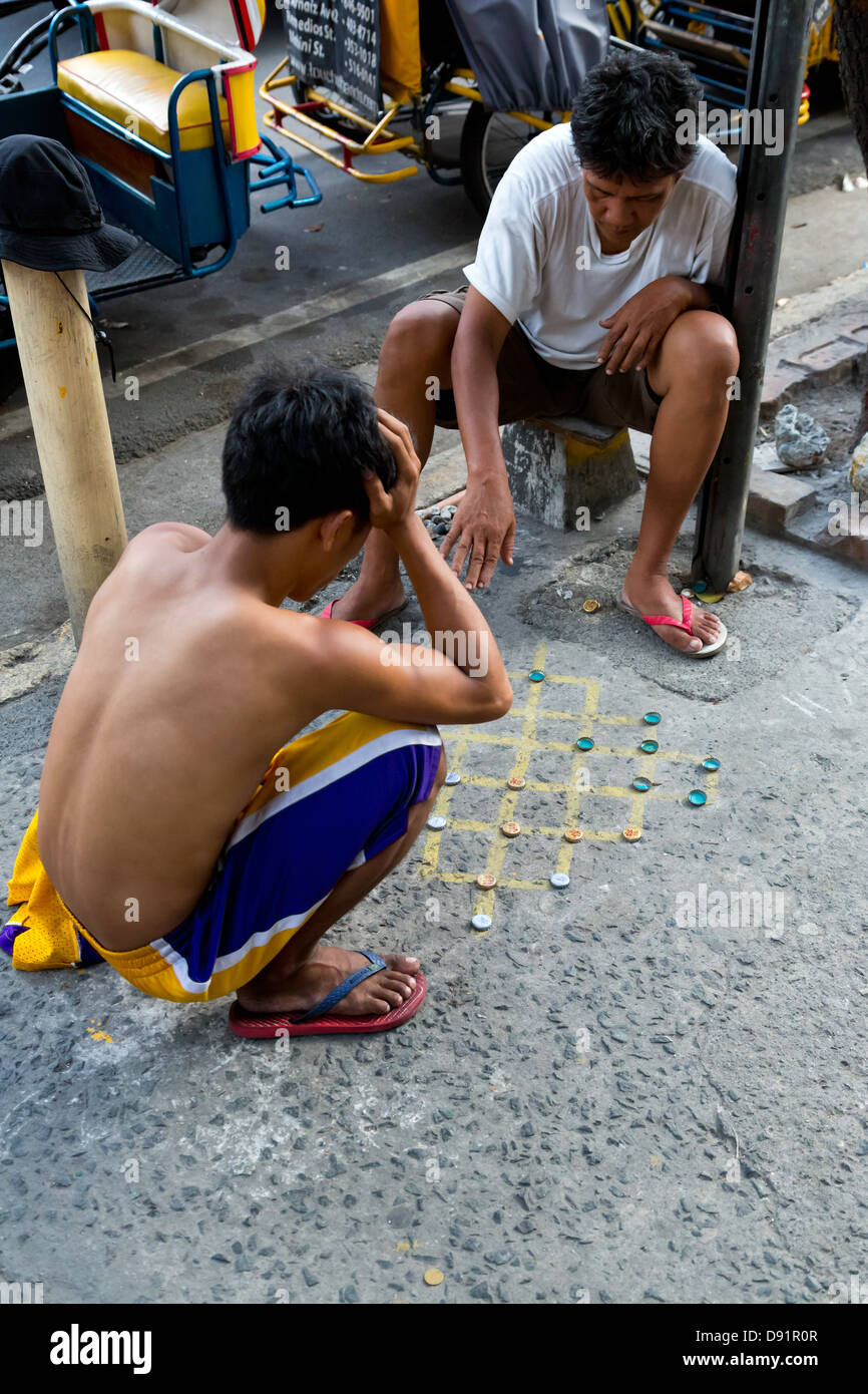Men gambling on the Sidewalk in Manila, Philippines Stock Photo Alamy