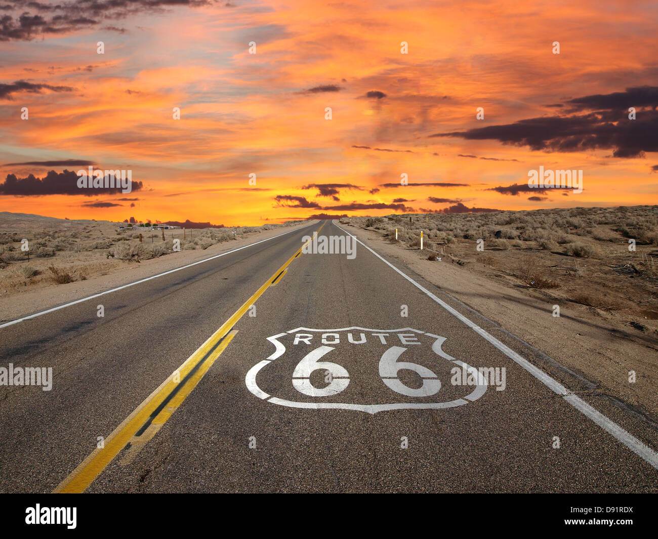 Route 66 pavement sign sunrise in California's Mojave desert. Stock Photo