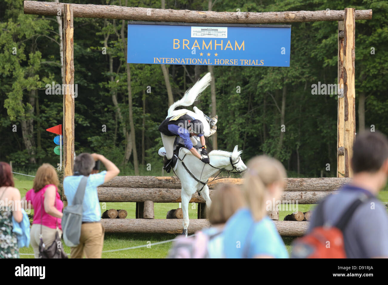Leeds Bramham UK. 8th June 2013. Spectators look on in horror as a riderI is involved in a dramatic fall during the cross country event at the 40th Bramham horse trials, both horse and rider were not seriously injured. Credit: S D Schofield/Alamy Live News Stock Photo