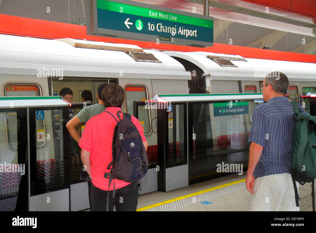 Singapore Tanah Merah MRT Station,East West Line,subway train,riders,commuters,Asian man men male,platform,Sing130206058 Stock Photo