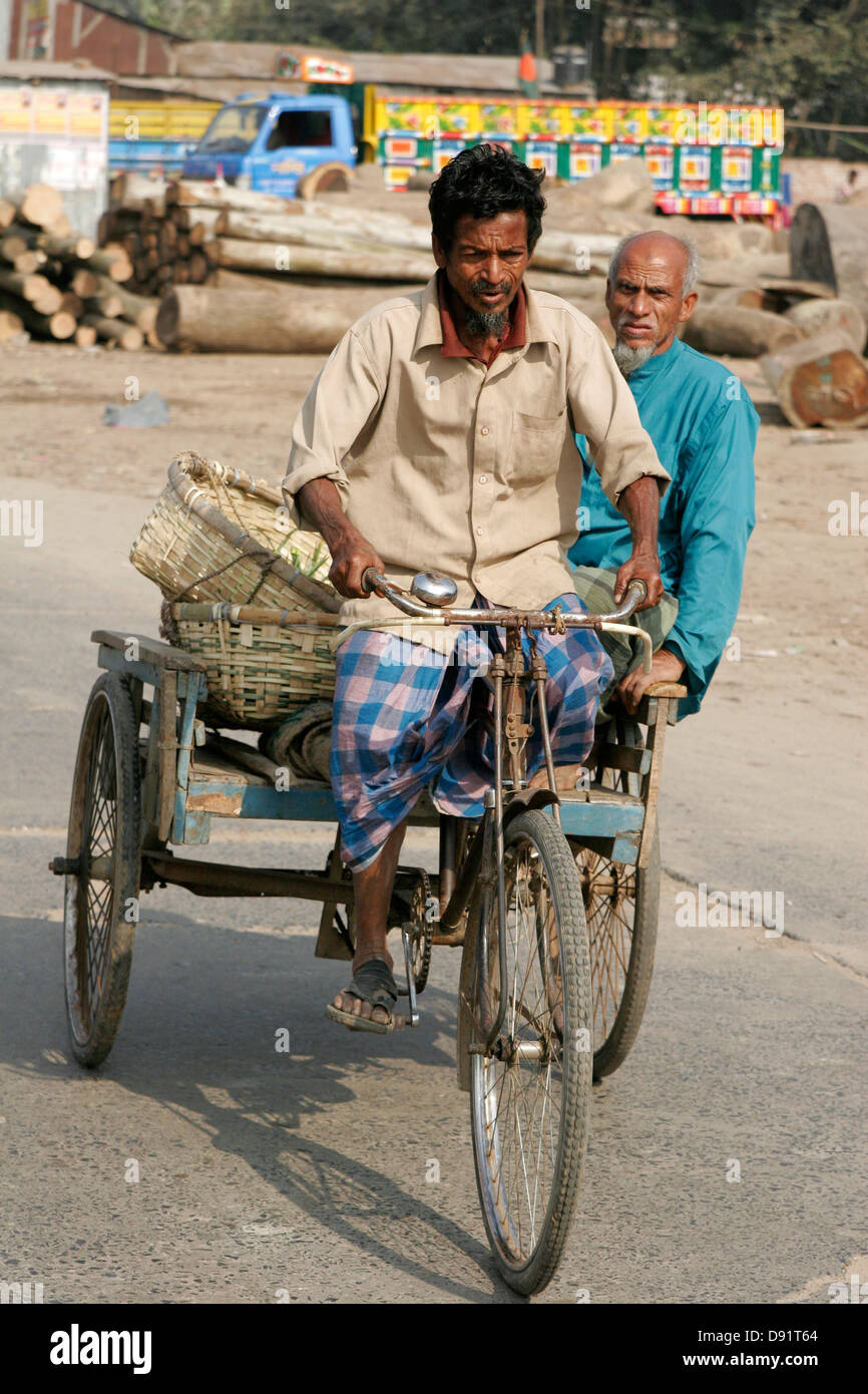 Rickshaw carrying passenger and woven baskets, Bangladesh Stock Photo ...