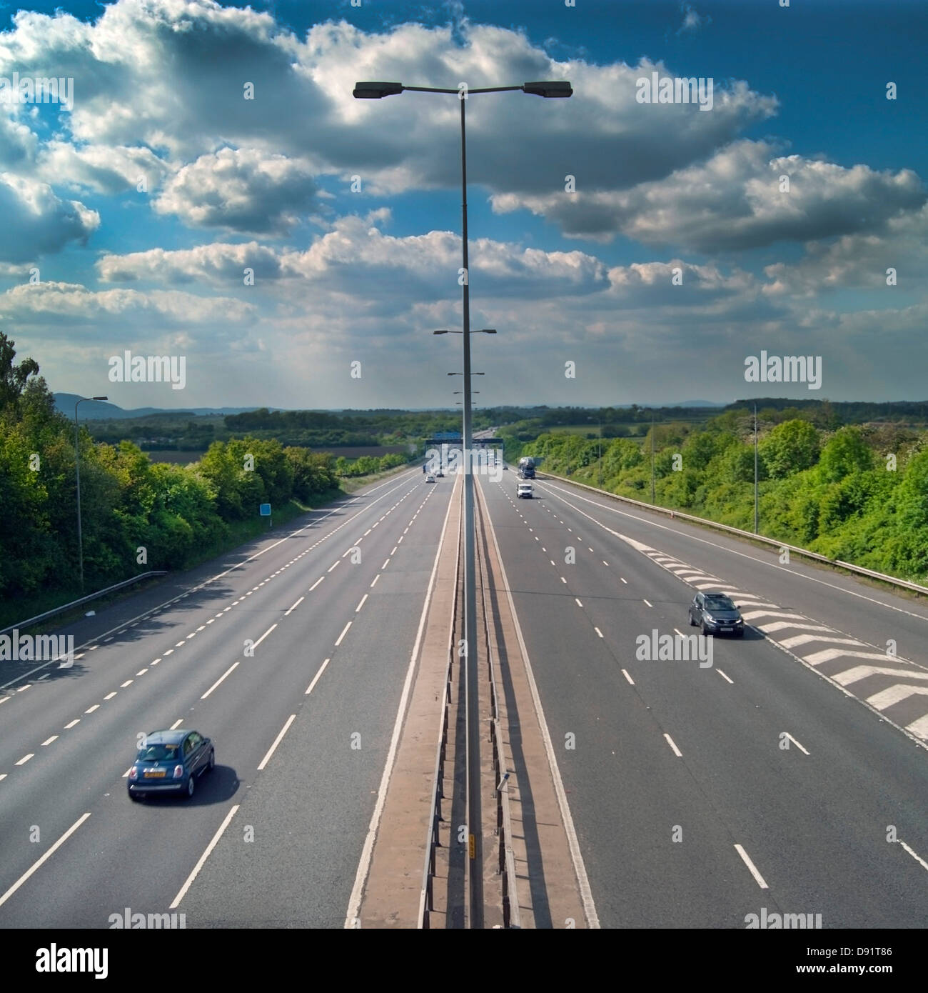 Lighting in the middle of a wide empty motorway. Stock Photo