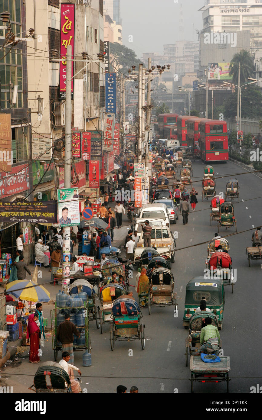 Rickshaw and bus traffic on the street of Dhaka, Bangladesh Stock Photo