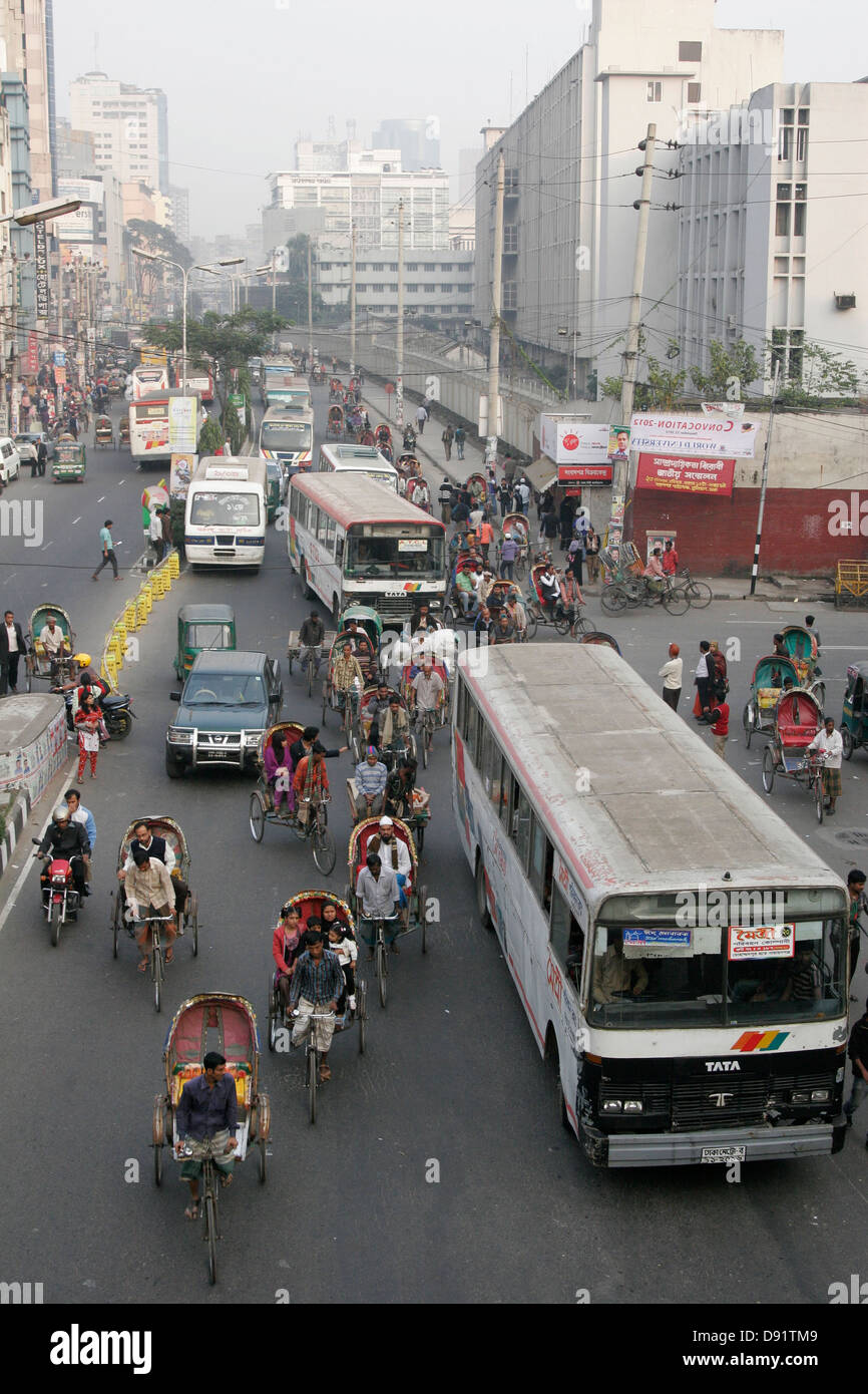 Rickshaw and bus traffic on the street of Dhaka, Bangladesh Stock Photo