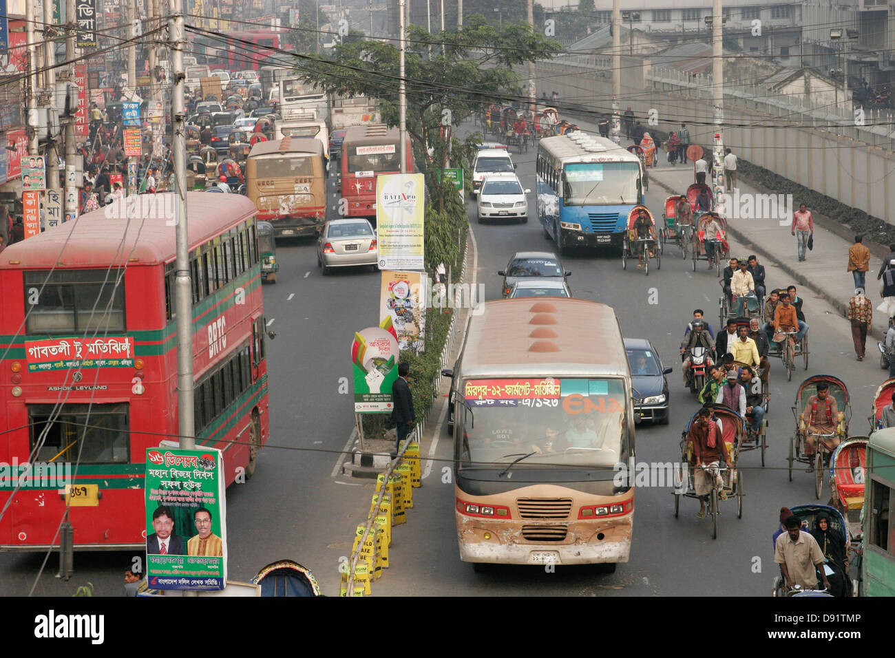 Rickshaw and bus traffic on the street of Dhaka, Bangladesh Stock Photo