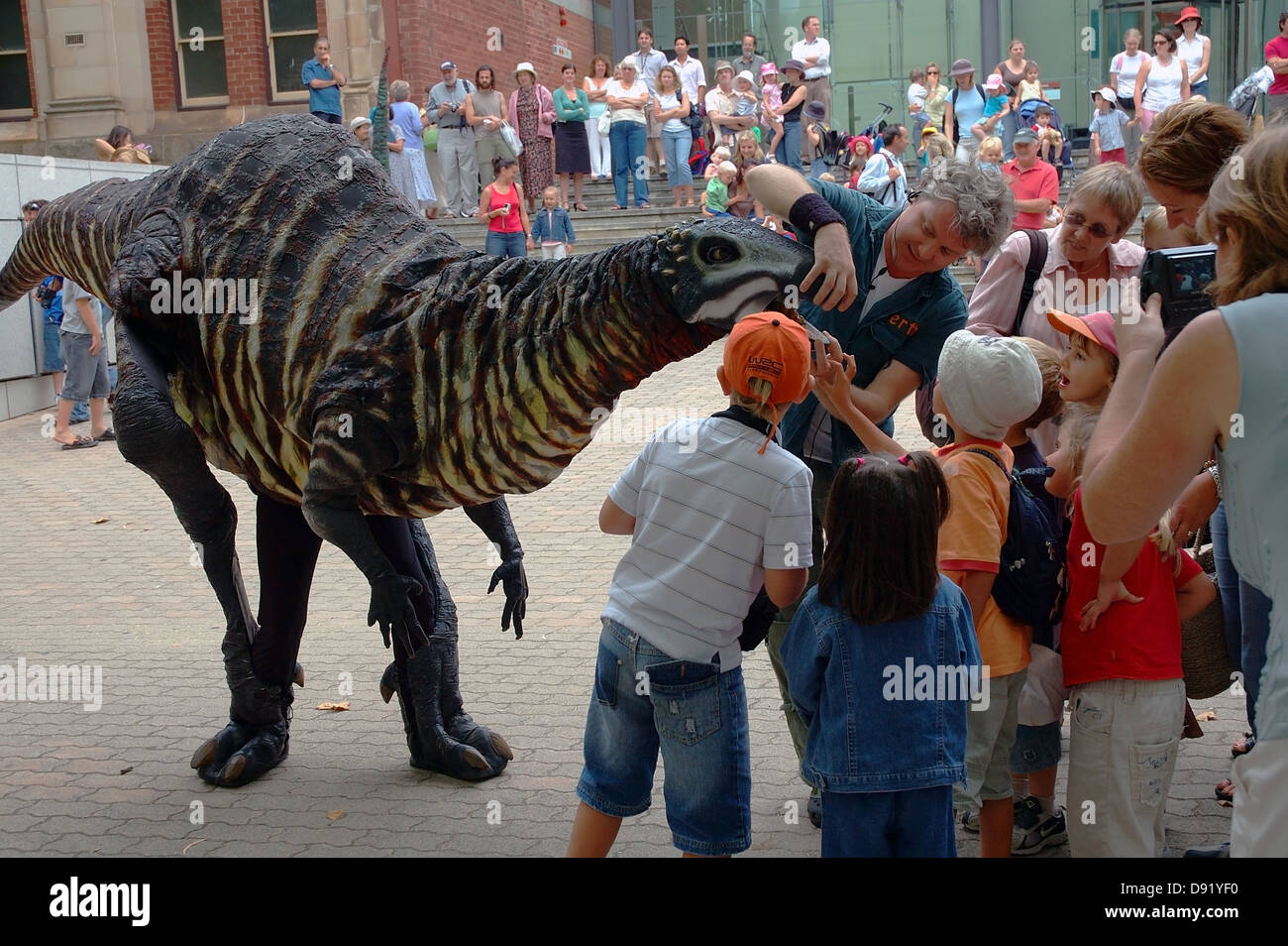 Children meet lifesized mobile dinosaur puppets at the Western Australian Museum, Perth Stock Photo