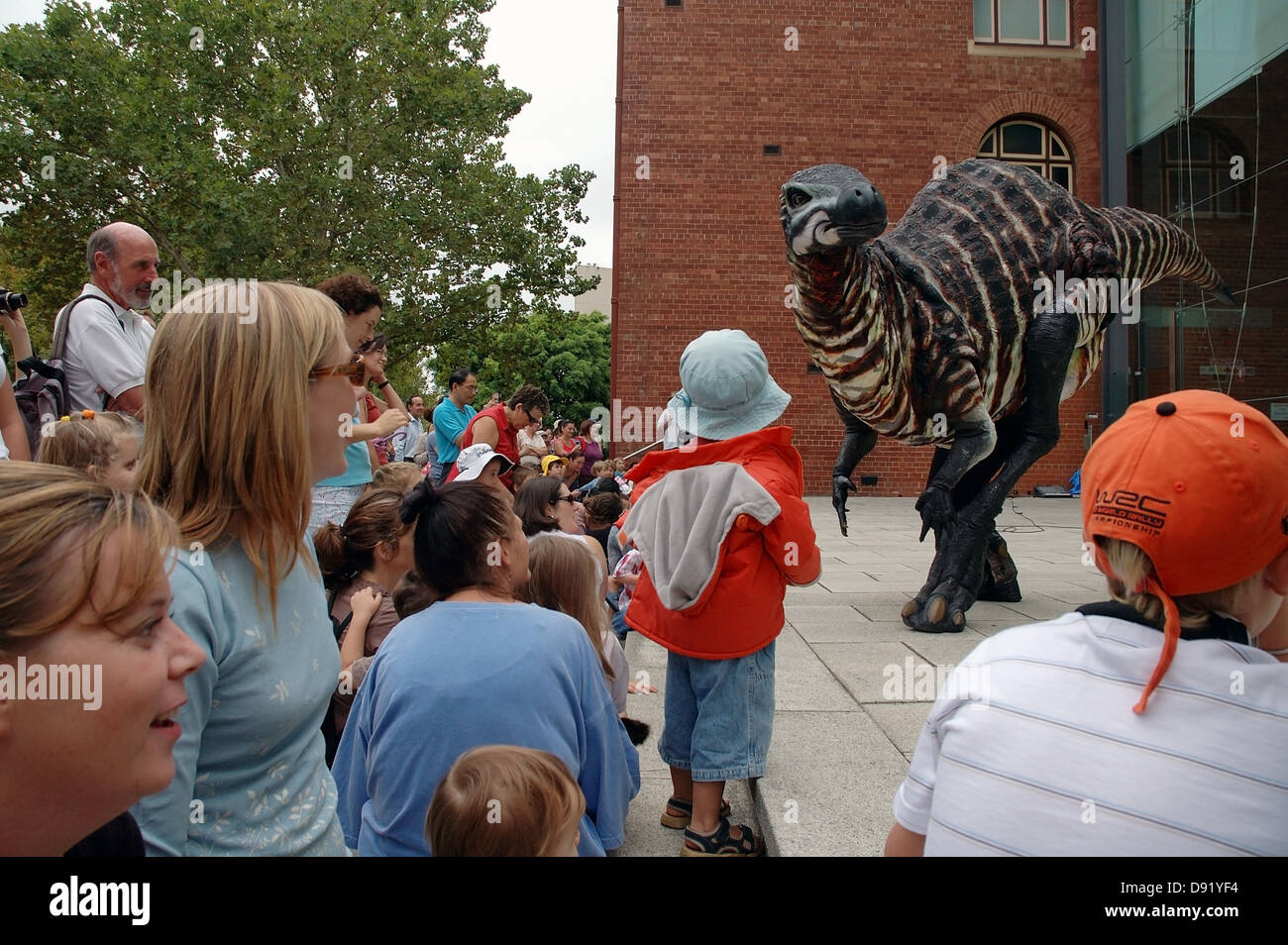 Children meet lifesized mobile dinosaur puppets at the Western Australian Museum, Perth Stock Photo