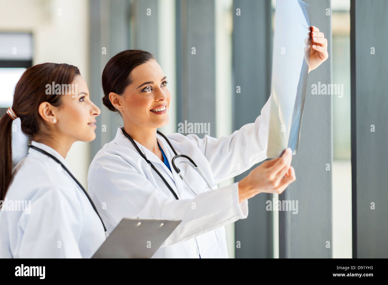 two female medical workers looking at patient's x-ray film Stock Photo