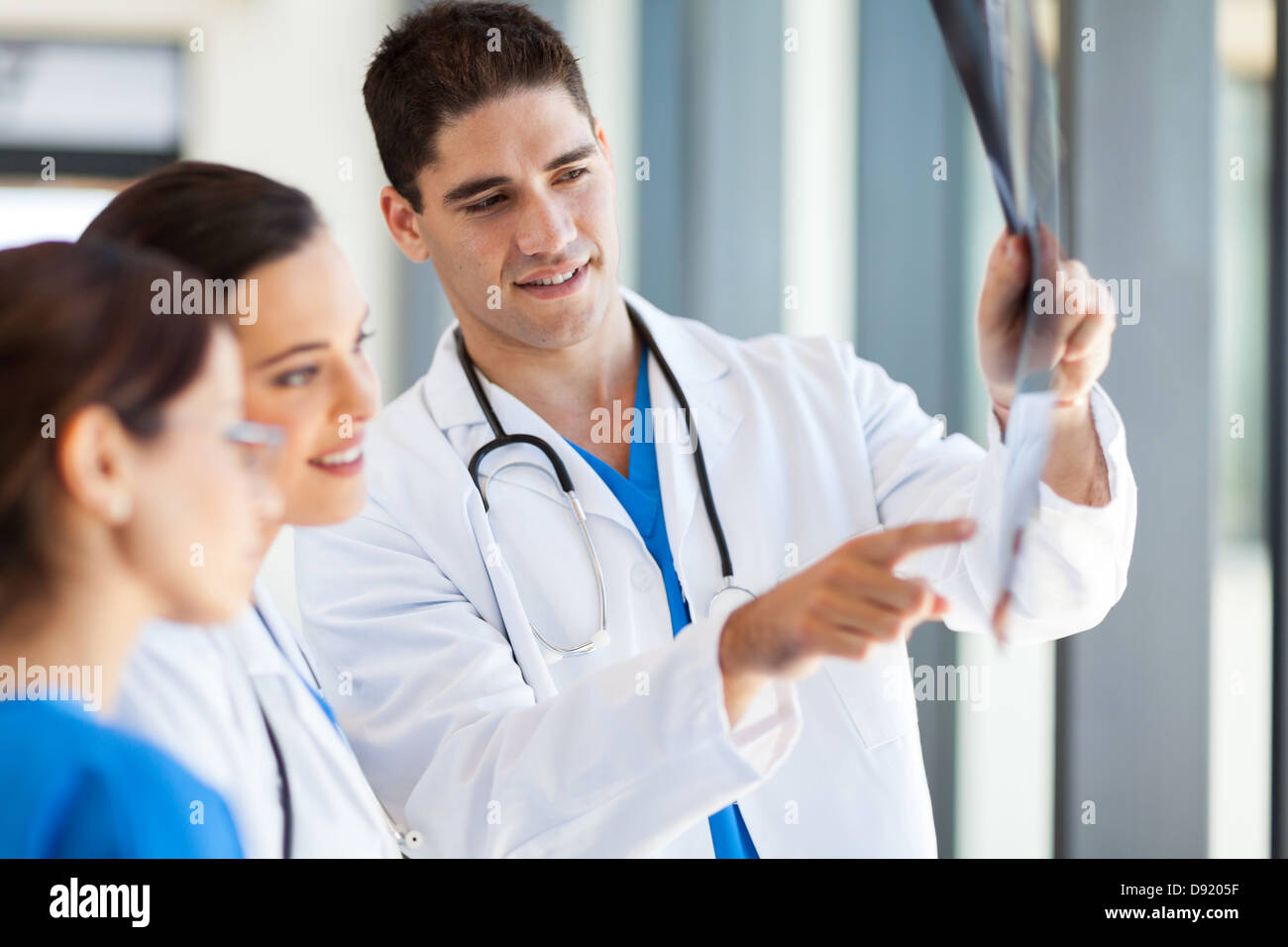 group of medical workers looking at patient's x-ray film Stock Photo