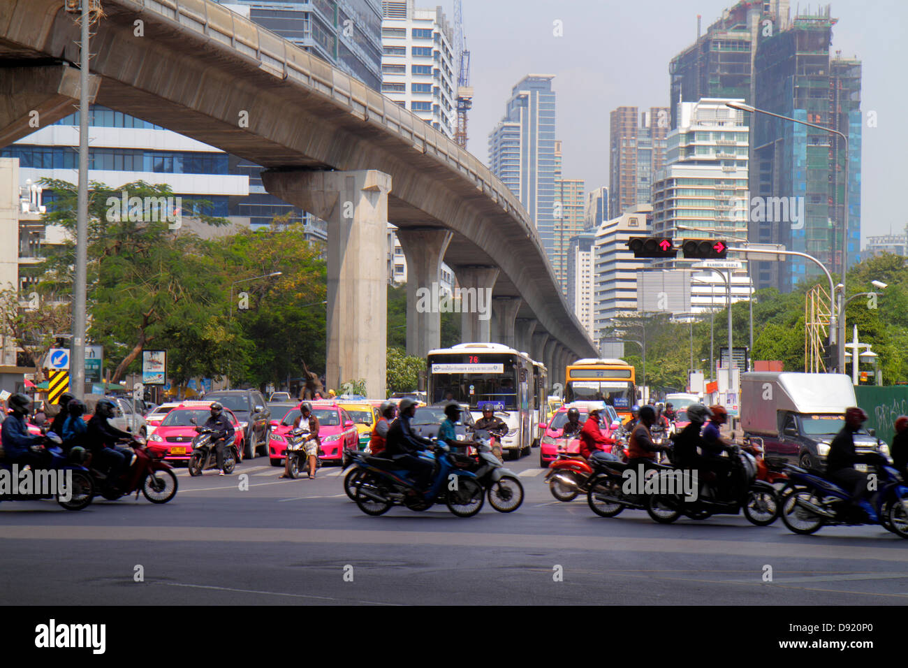 Thailand,Thai,Bangkok,Silom,Ratchadamri Road,Rama IV,Sala Deang Junction,intersection,Bangkok Mass Transit System,BTS Skytrain,traffic,motorcycles,mot Stock Photo