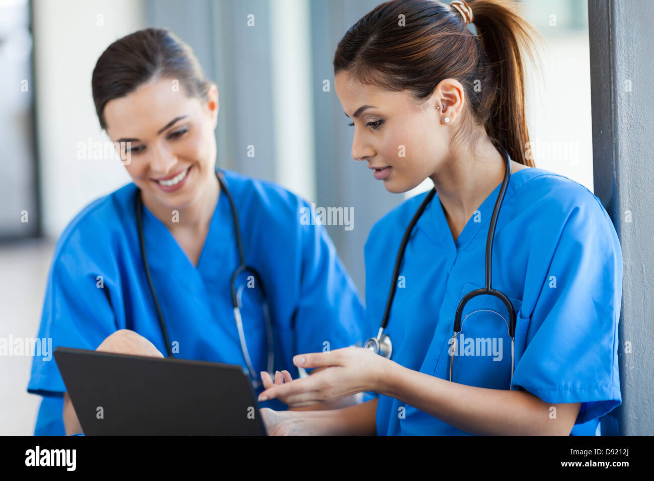 two beautiful female healthcare workers using laptop Stock Photo