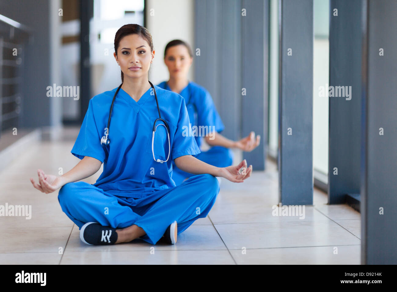 two young healthcare workers meditation during break to release work pressure Stock Photo