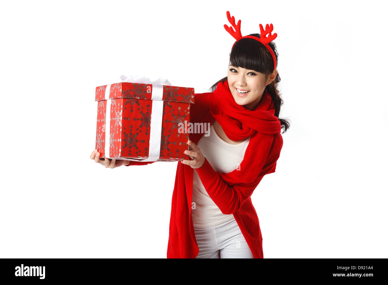 Young woman holding Christmas gift Stock Photo - Alamy