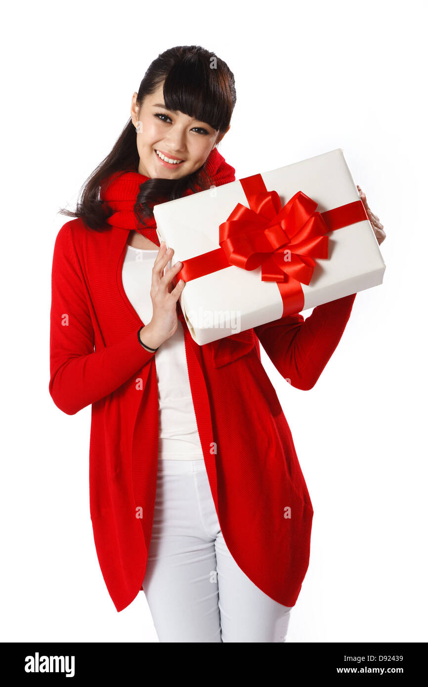 Young woman holding Christmas gift Stock Photo - Alamy
