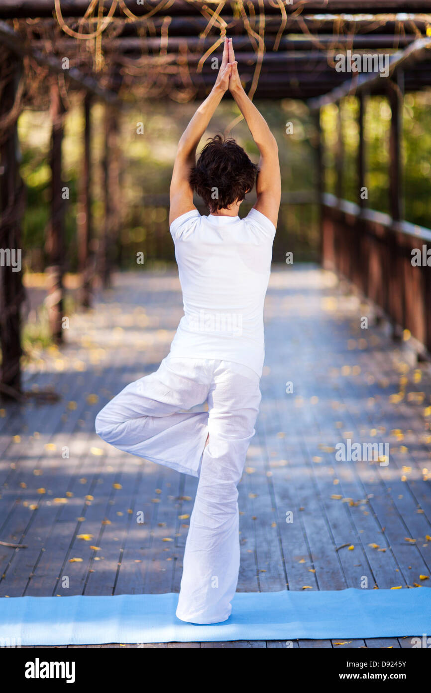rear view of middle aged woman doing yoga pose Stock Photo - Alamy