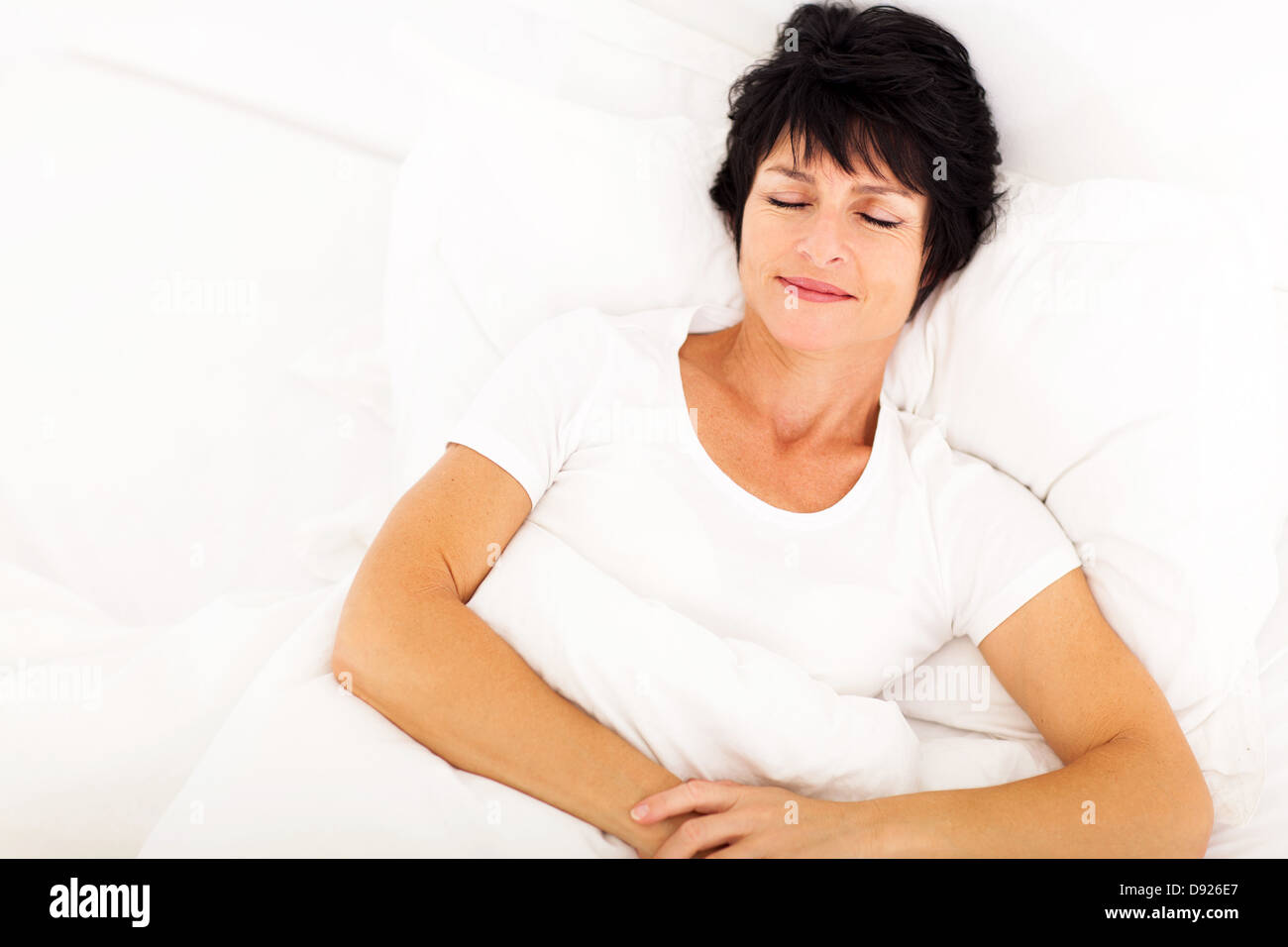 overhead view of elegant middle aged woman sleeping on bed Stock Photo