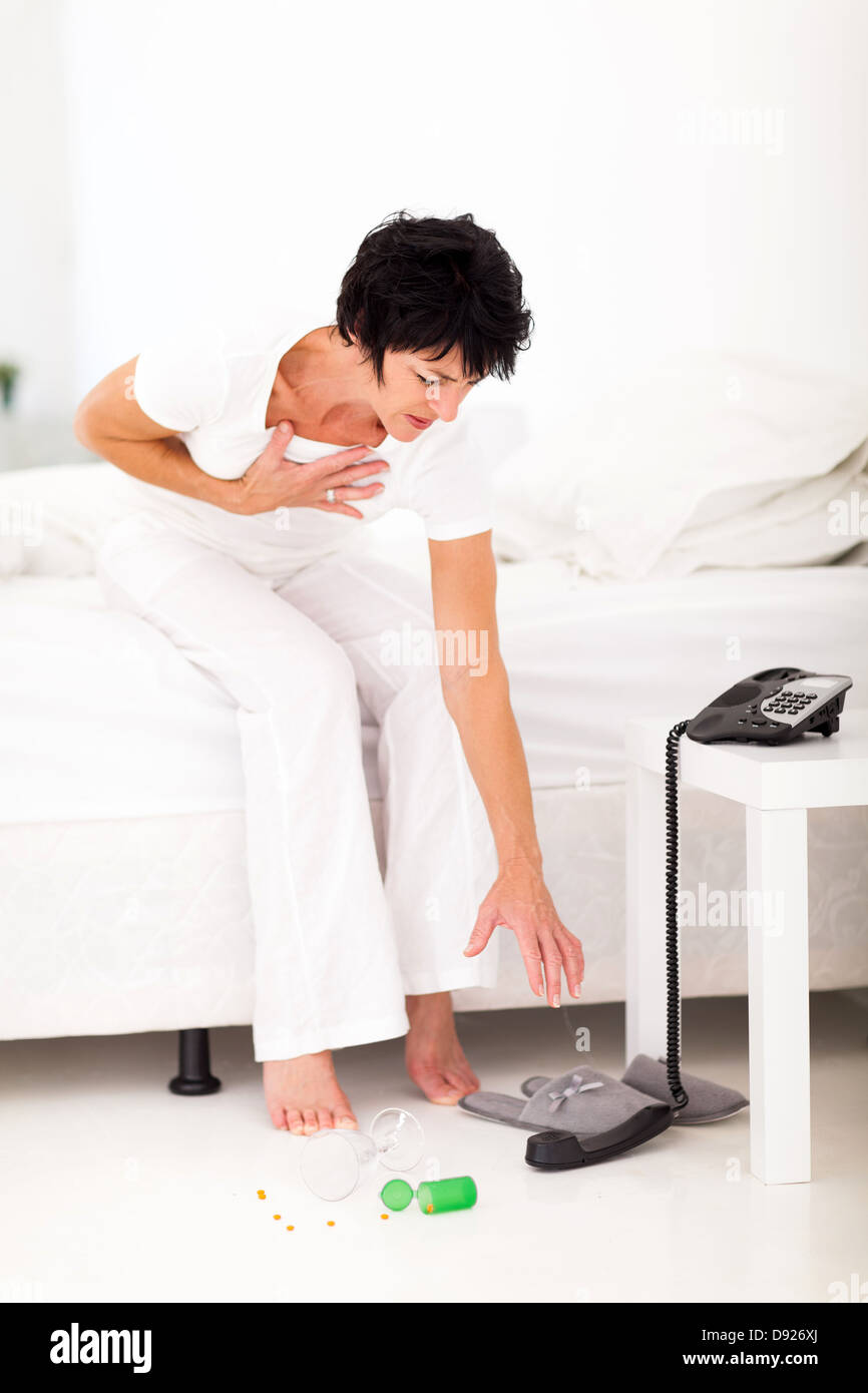 middle aged woman having heart attack emergency Stock Photo