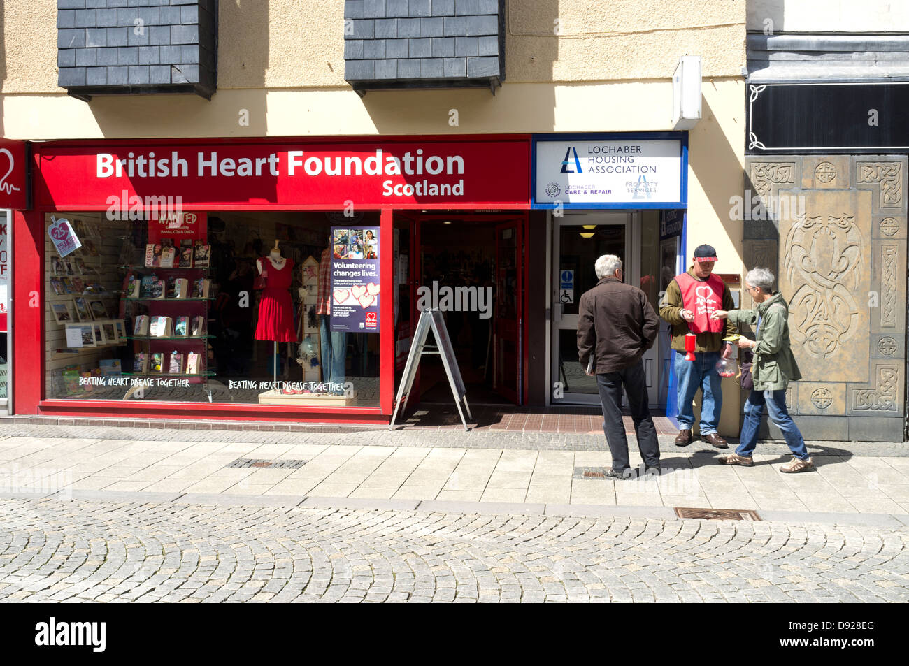 A woman makes a donation to The British Heart Foundation Fort William Scotland UK Stock Photo