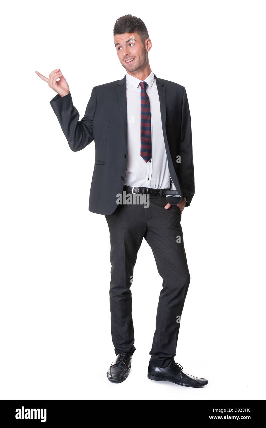 Happy young businessman, full length, pointing to side, isolated on white Stock Photo