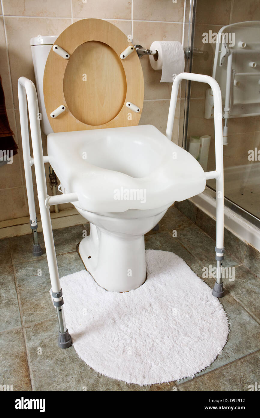 Adjustable height toilet seat fitted to an existing toilet recommended by occupational therapist for elderly, disabled or infirm Stock Photo