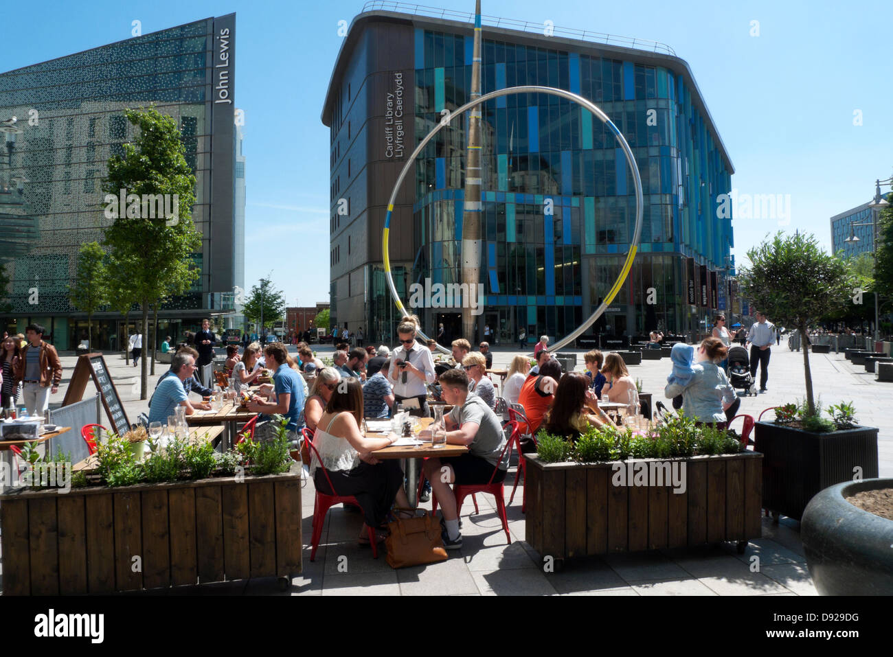 People dining al fresco in summer sunshine at Jamie Oliver Italian Restaurant by John Lewis & Library Cardiff City Centre Wales UK  KATHY DEWITT Stock Photo