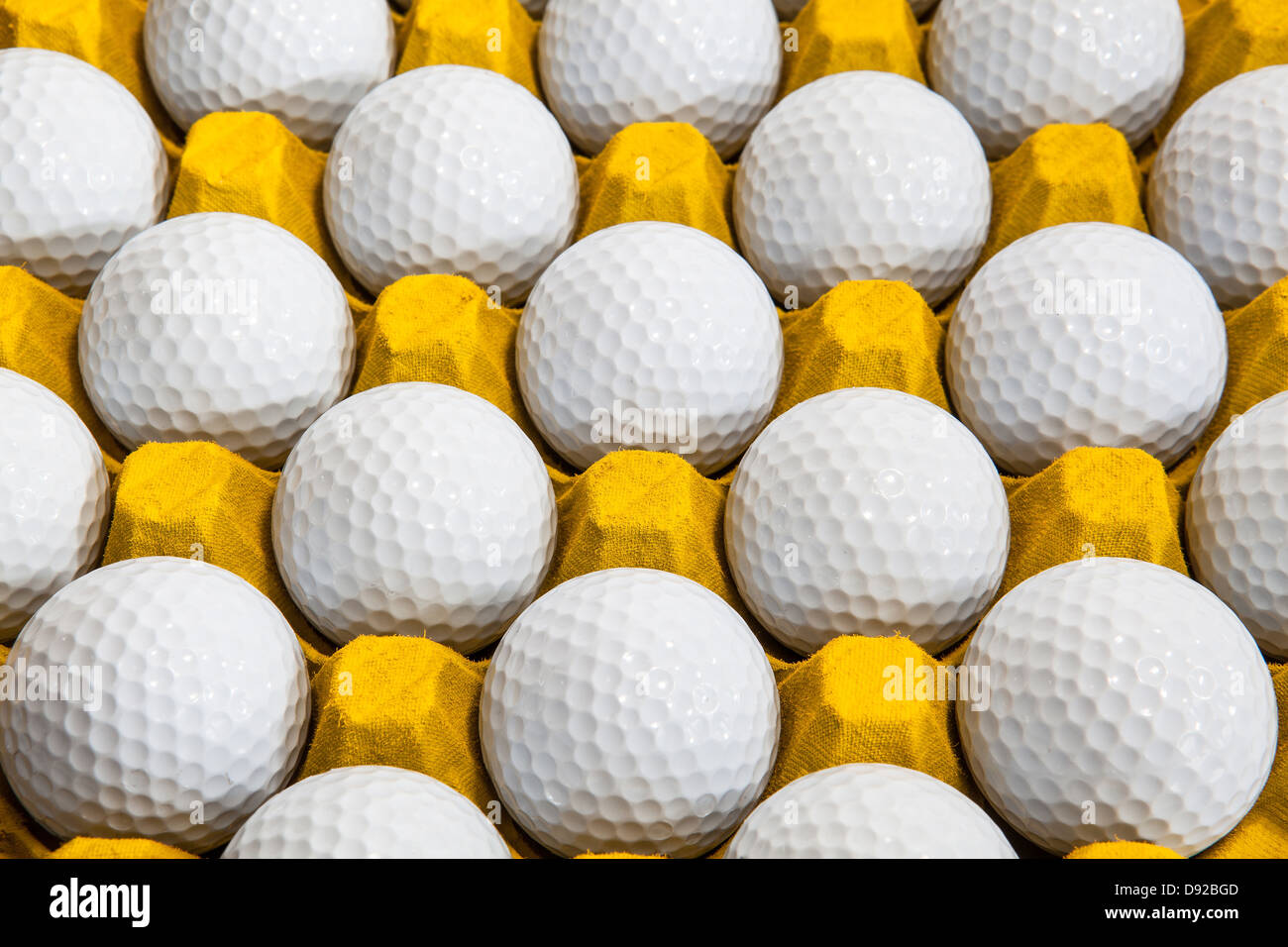 Golf balls in a box for eggs Stock Photo Alamy