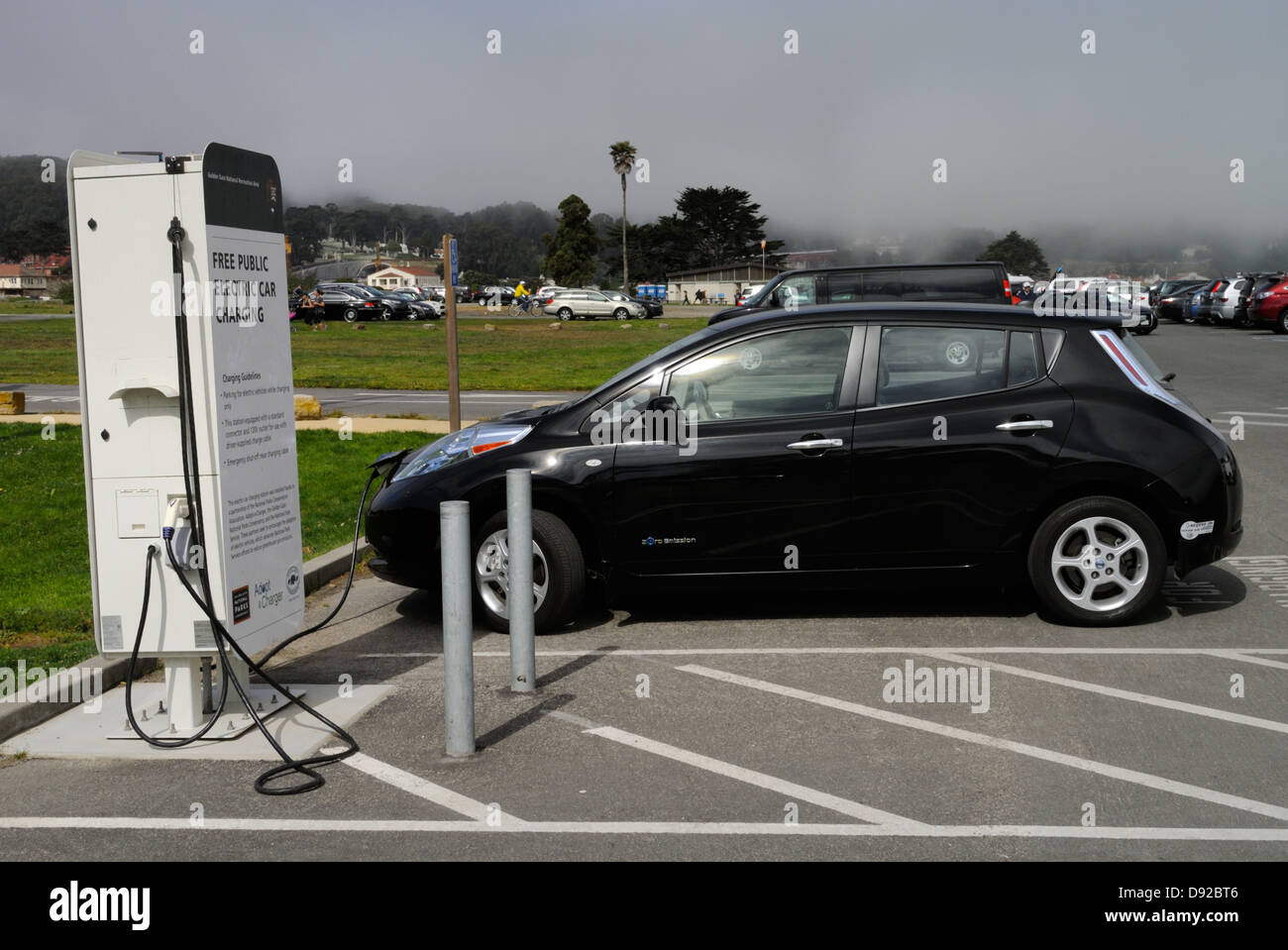 Electric car (Nissan Leaf) at a free charging station, San Francisco CA