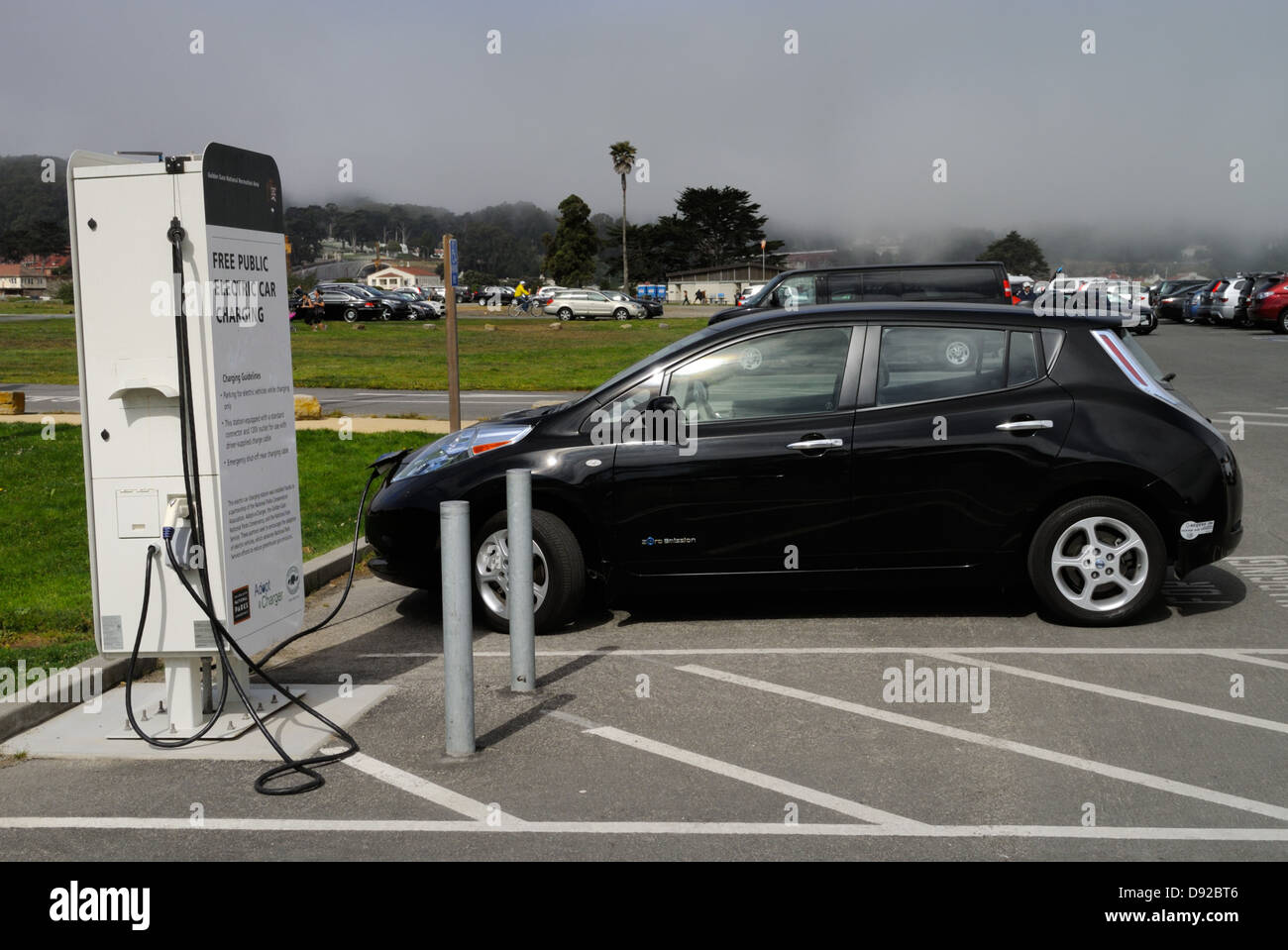 Electric car (Nissan Leaf) at a free charging station, San Francisco CA Stock Photo