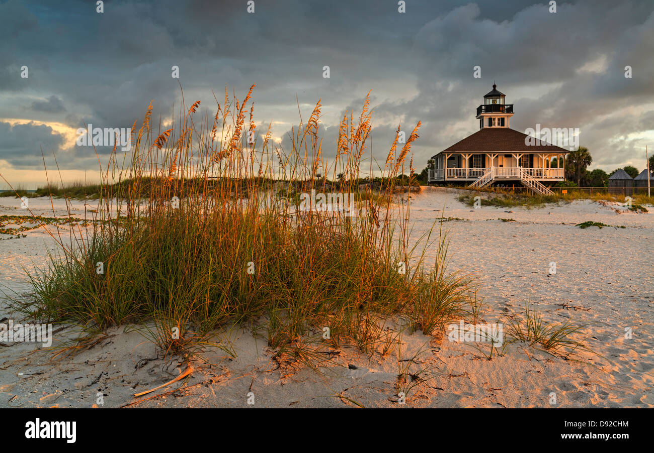 Golden Morning light glances across grasses and the lighthouse, Boca Grande Beach, Florida Stock Photo