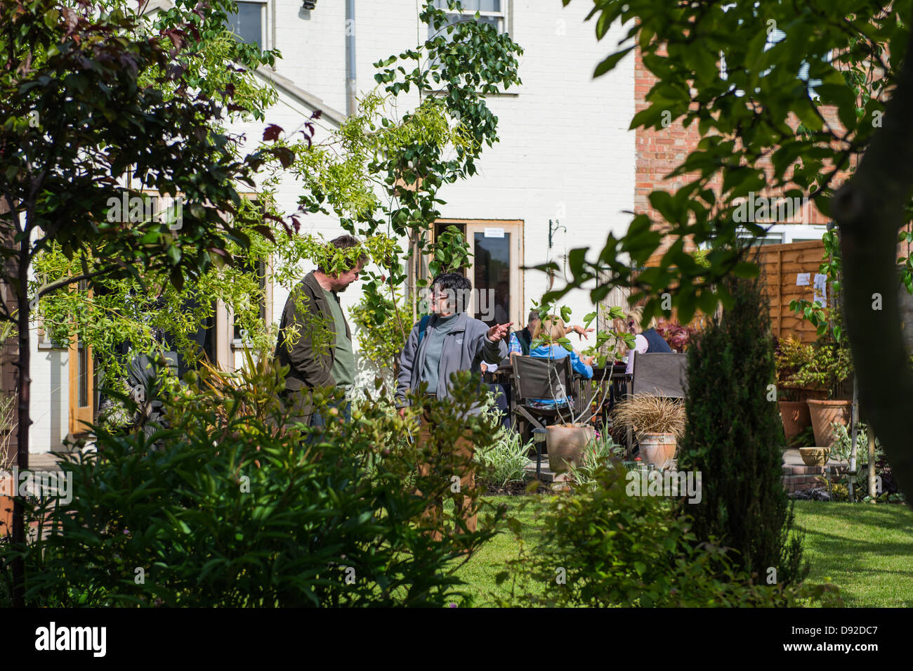 People discussing a garden at an Open Garden event in Peterborough. Stock Photo