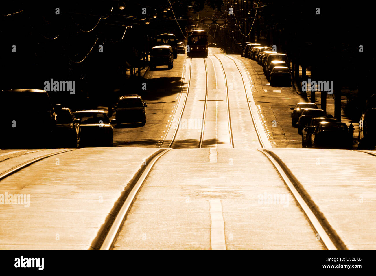 Toned perspective shot of street with rise and streetcar coming down the road Stock Photo