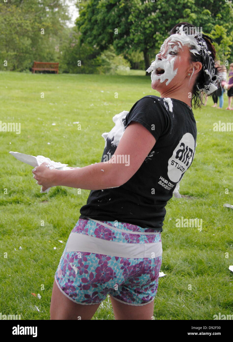 Bakewell, Derbyshire, UK. 9 June 2013.  Paula Sutherill from the winning all-girls team takes a custard pie hit at the Mr. Darcy Custard Pie Fight, Bakewell Baking Festival, Derbyshire, UK.  Mr Darcy's Custard Pie Fight marked the 200th anniversary of Jane Austen's Pride and Prejudice that was part-written in Bakewell's Rutland Arms Hotel.  Teams, with one member dressed as Mr. Darcy, launched pies whilst attempting to keep their Darcy clean.  An all-girl team from Matlock was declared winner. Credit:  Deborah Vernon/Alamy Live News Stock Photo