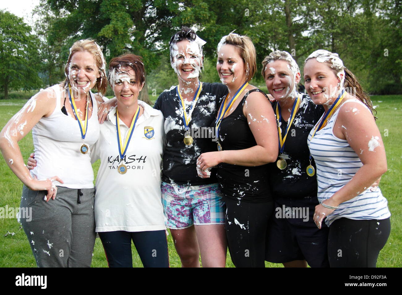 Bakewell, Derbyshire, UK. 9 June 2013.  Mr. Darcy Custard Pie Fight all-girl winning team from Matlock, Derbyshire.  (l-r) Nicola Crowder, Andrea Rodgers, Paula Sutherill, Aimee Wood, Liz Ashmore, Liz McGovern.  Mr. Darcy Custard Pie Fight, Bakewell Baking Festival, Derbyshire, UK.  Mr Darcy's Custard Pie Fight marked the 200th anniversary of Jane Austen's Pride and Prejudice that was part-written in Bakewell's Rutland Arms Hotel.  Teams, with one member dressed as Mr. Darcy, launched pies whilst attempting to keep their Darcy clean. Credit:  Deborah Vernon/Alamy Live News Stock Photo