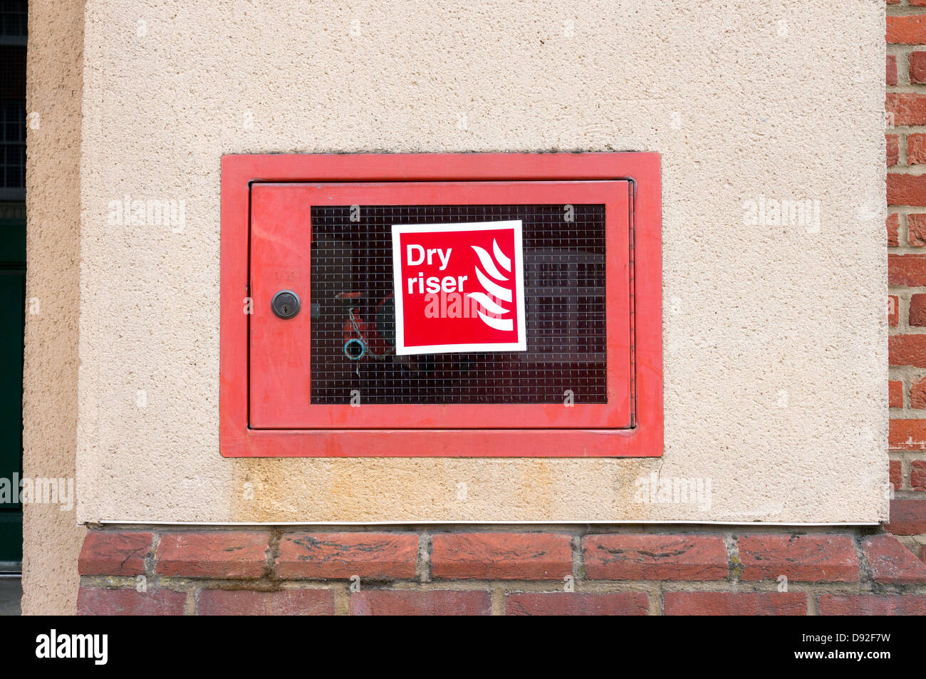 Dry riser emergency water supply for Fire Brigade to use behind locked toughened glass door Stock Photo