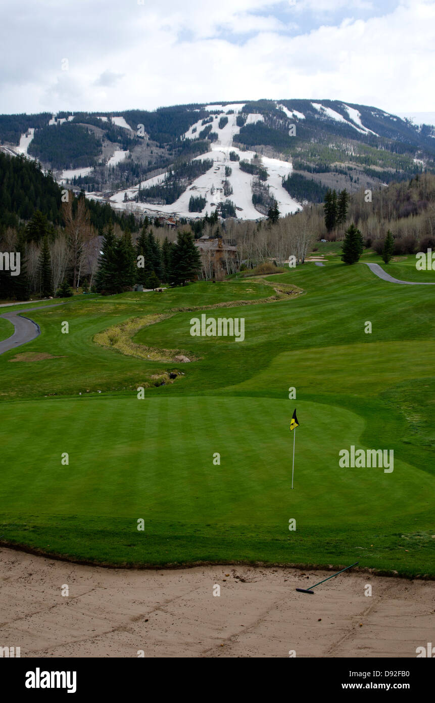 Combining two sports from separate seasons, a tourist can play golf on the Beaver Creek Golf Course on the same day they ski. Stock Photo