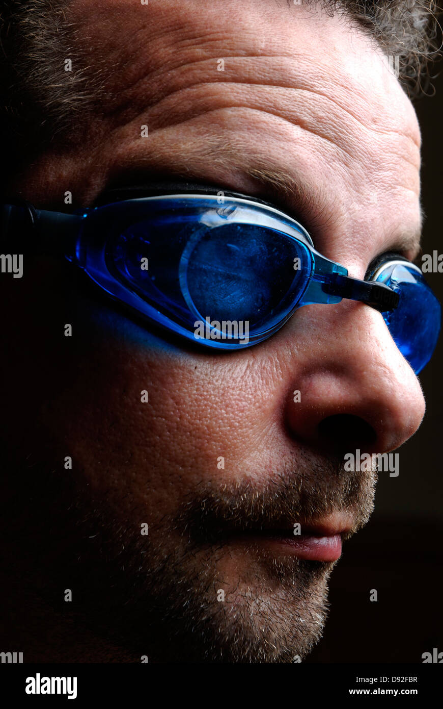 A man with blue swimming goggles Stock Photo