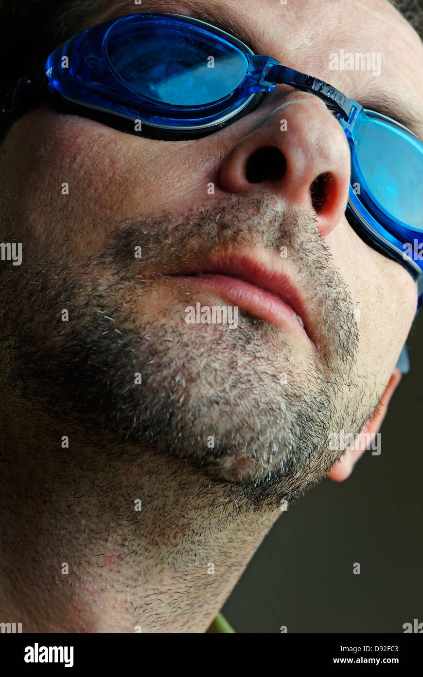 A man with blue swimming goggles Stock Photo