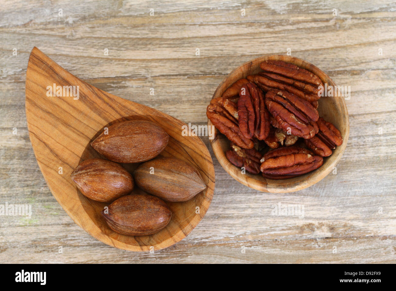 Pecan nuts with and without shell in wooden bowls Stock Photo Alamy