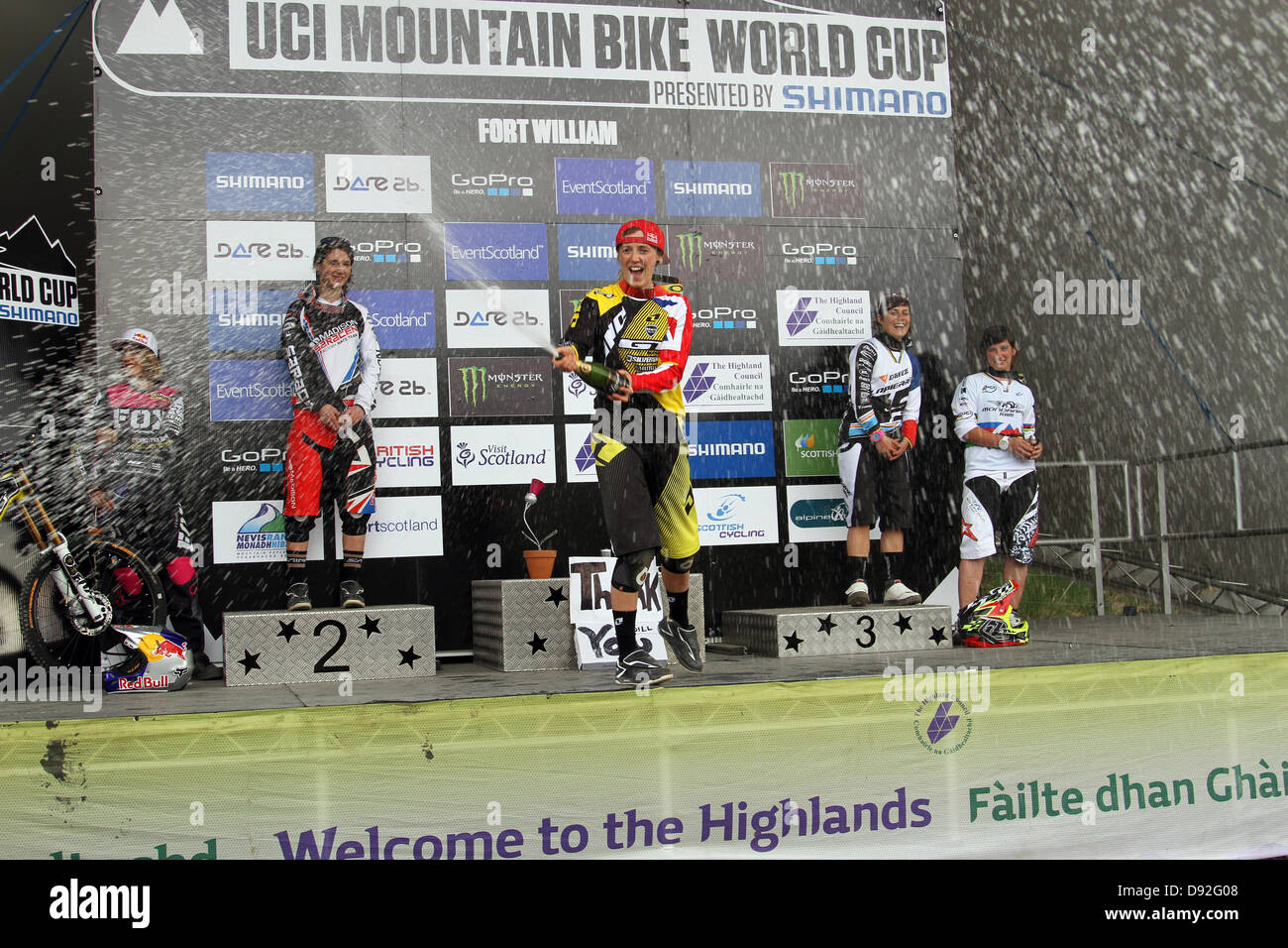 Winner of the 1st round of the Downhill Mountain Bike World Cup, Rachel Atherton, spraying champagne in celebration at Fort William. Stock Photo