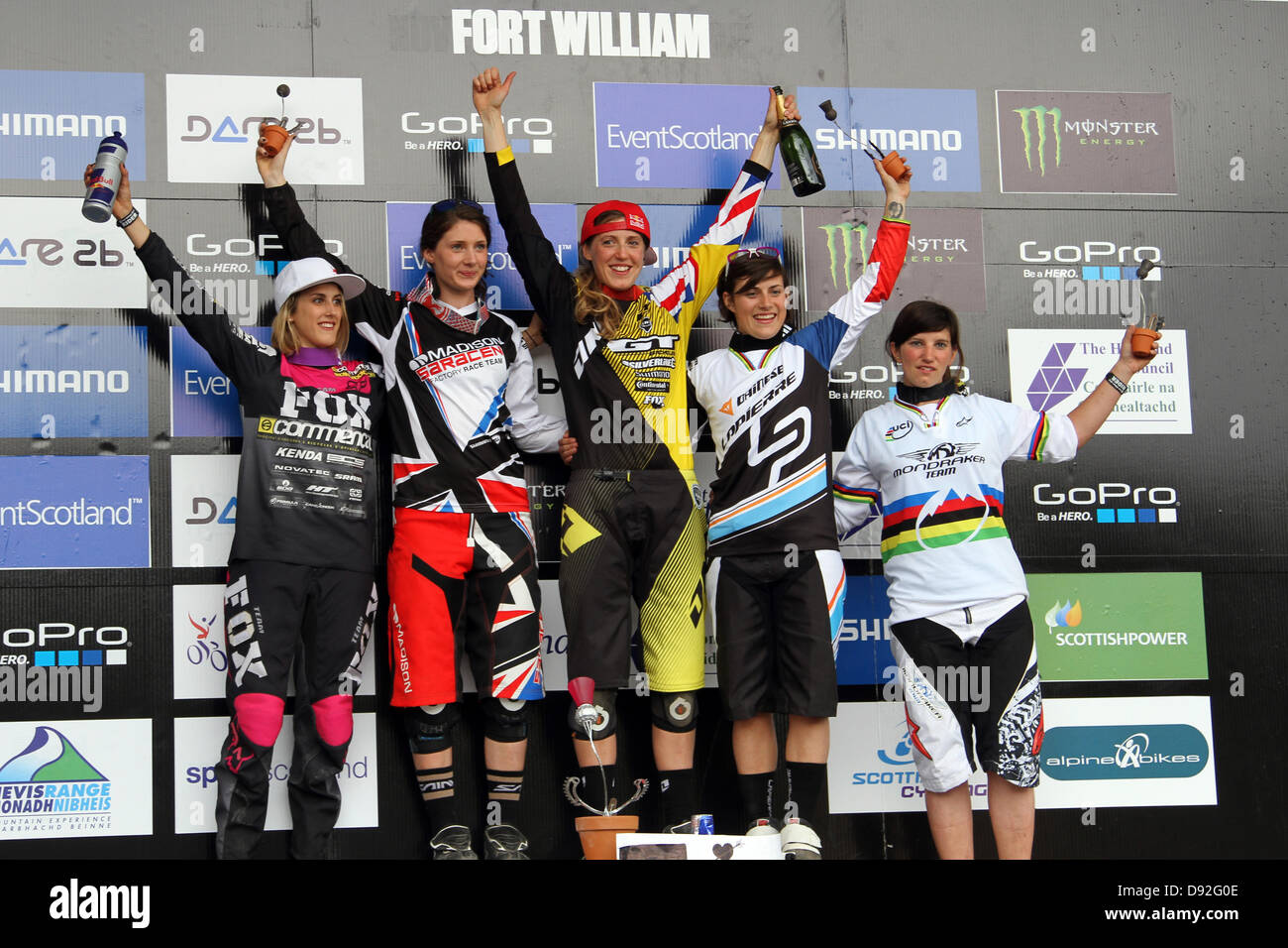 The women's podium, with winner Rachel Atherton (centre) acknowledging the crowd at the 1st round of the Downhill Mountain Bike World Cup, at Fort William 2013. Stock Photo