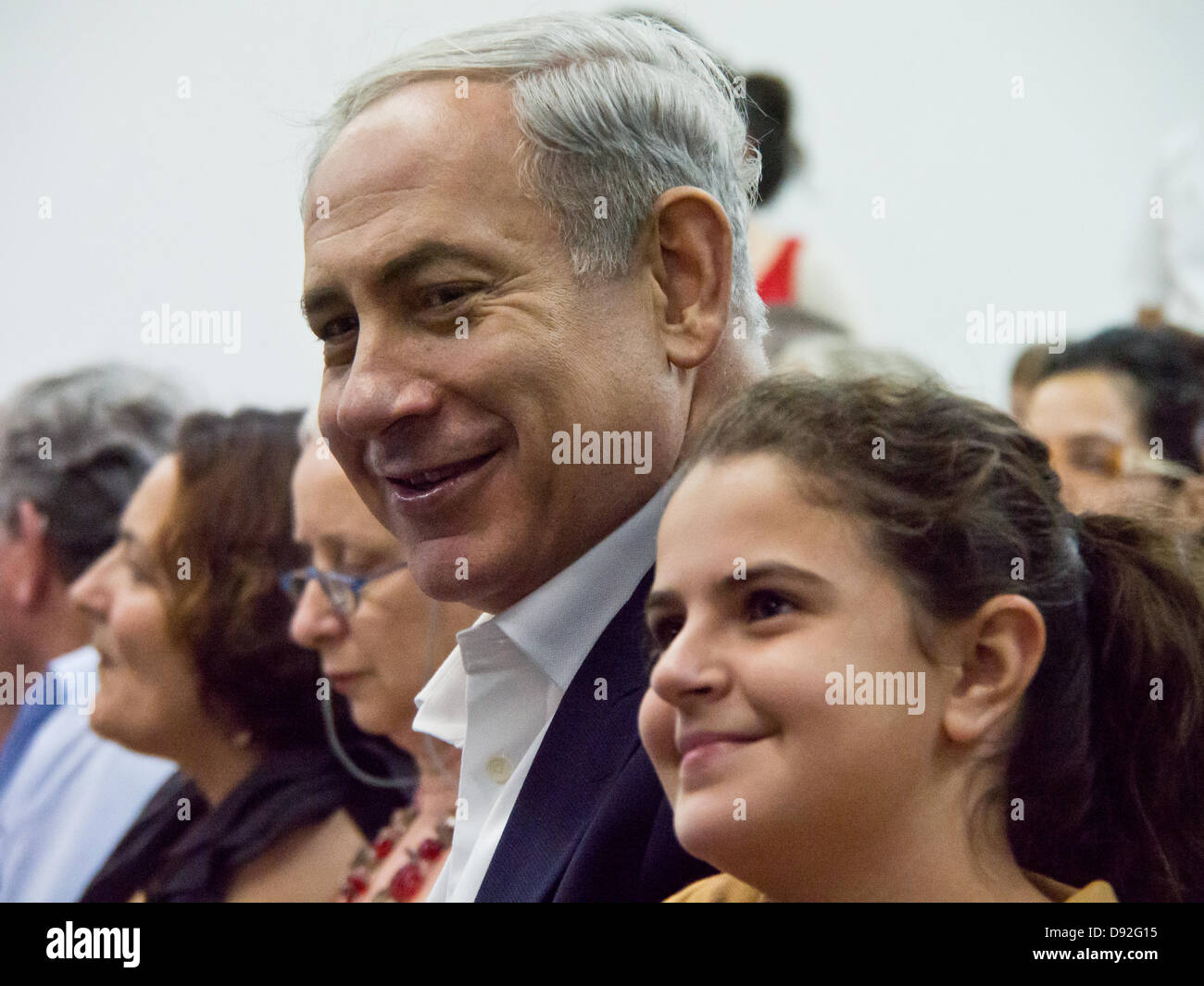 Prime Minister BENJAMIN NETANYAHU poses for a photo with a young girl as he attends son's high school graduation ceremony. Jerusalem, Israel. 9-June-2013.  Prime Minister Benjamin Netanyahu and wife Sarah Netanyahu attends son's high school graduation ceremony. Stock Photo